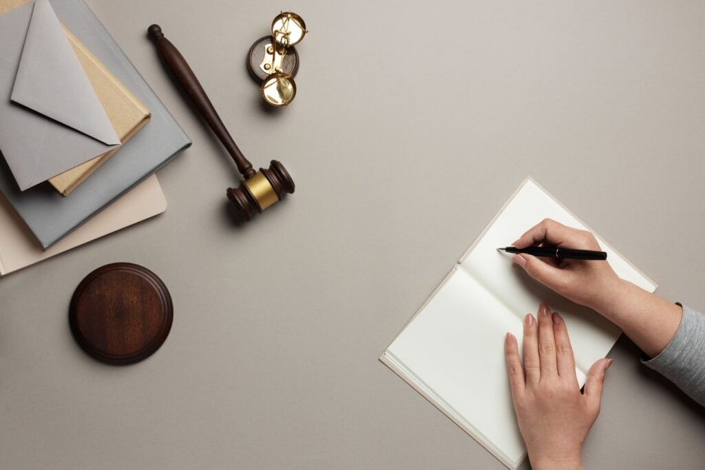 View over of women's hands write in a notebook