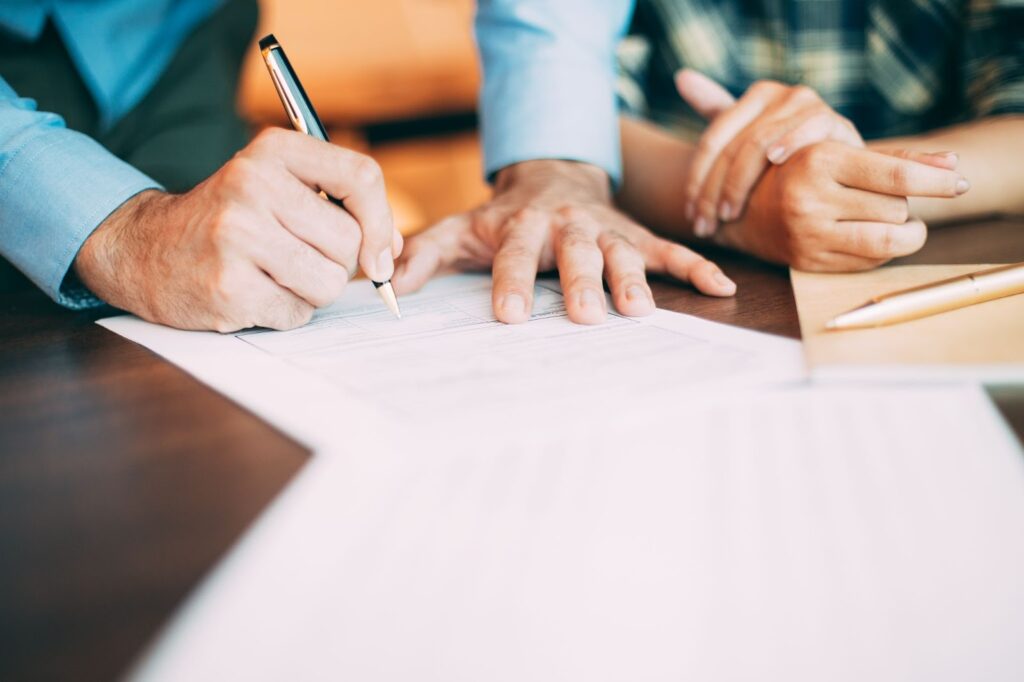 A man signing papers