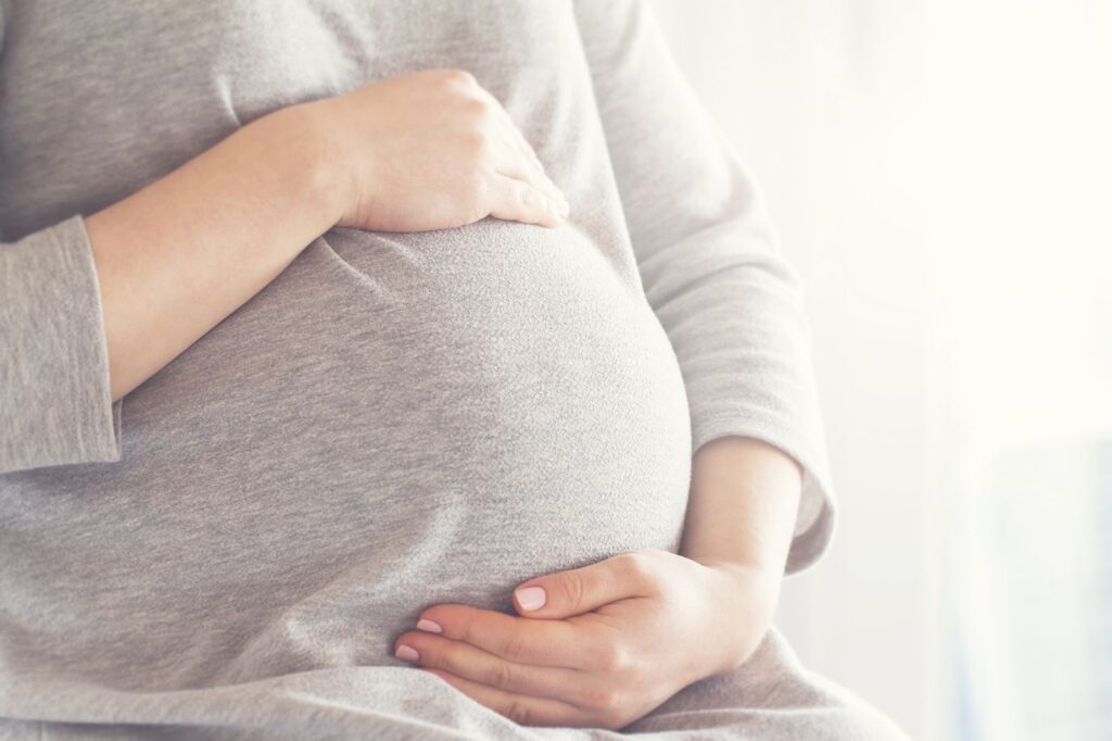 A woman holding her pregnant belly