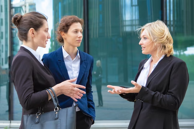 Confident business women discussing project emotionally outdoors