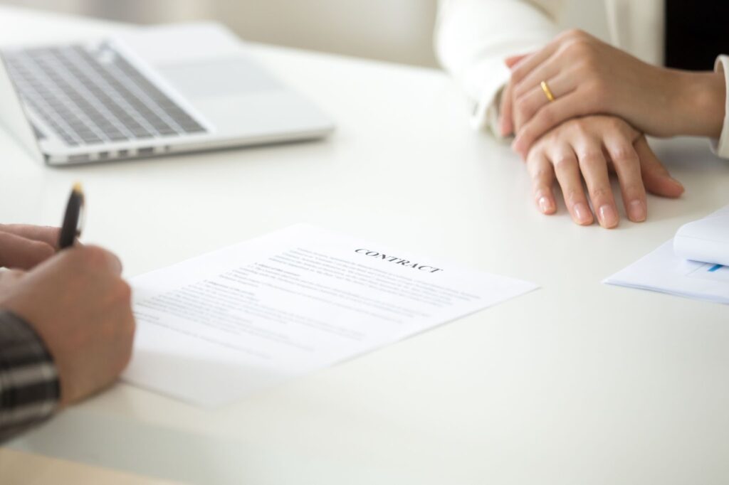 A man signing a contract